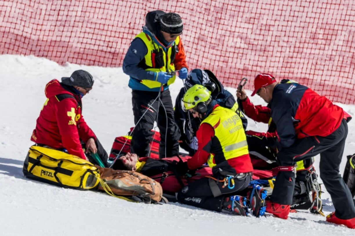 Rescuers give medical assistance to France's Nils Alphand after he crashed during a downhill training in Crans-Montana