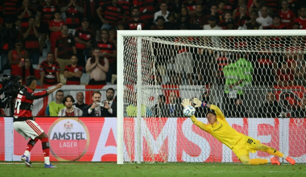 Estudiantes' Uruguayan goalkeeper Fernando Muslera saves a penalty by Flamengo's Bruno Henrique to help his team snatch victory in their Copa Libertadores semi-final