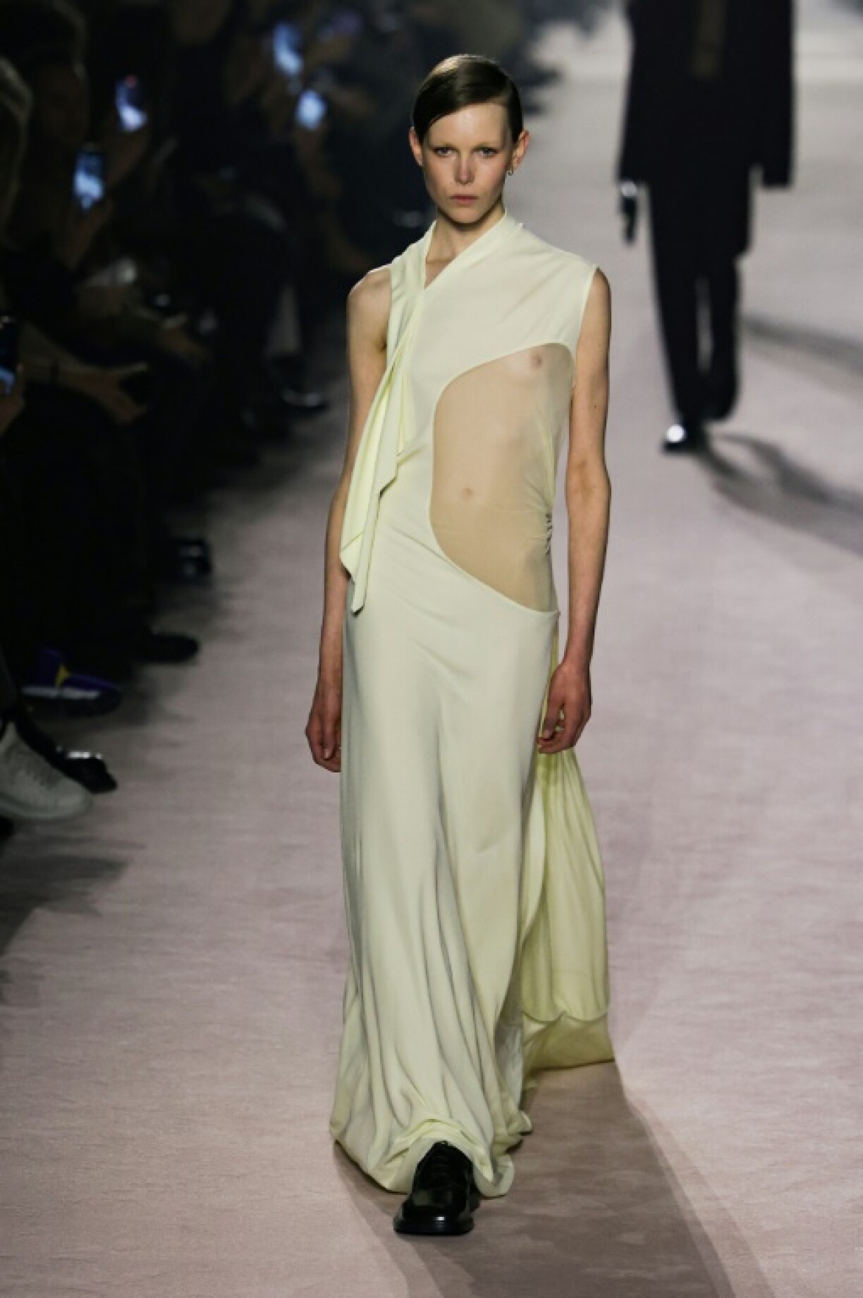 A model wearing a Victoria Beckham dress with a large cutaway