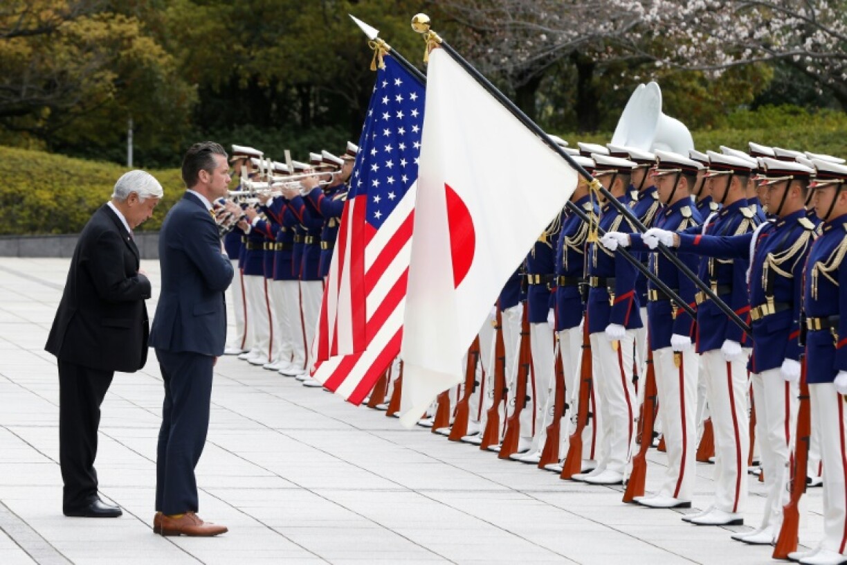 Japan's Defence Minister Gen Nakatani and US Secretary of Defense Pete Hegseth review an honor guard at the Ministry of Defence in Tokyo