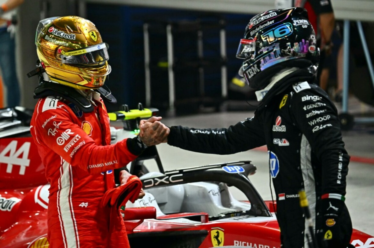 Ferrari's Lewis Hamilton (L) and Charles Leclerc congratulate each other at the end of qualifying for the Singapore Grand Prix