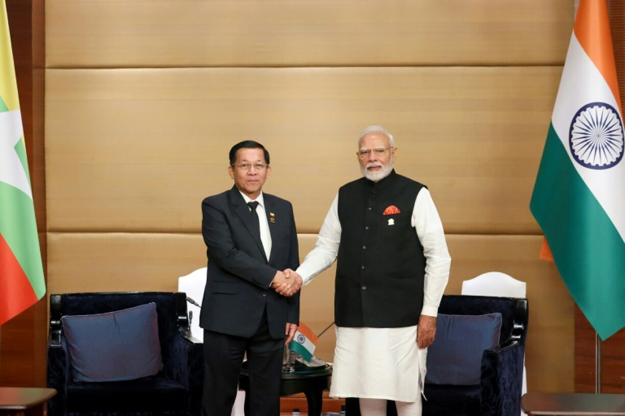 India's Prime Minister Narendra Modi (R) shakes hands with Myanmar's military chief Min Aung Hlaing on sidelines of the BIMSTEC Summit in Bangkok