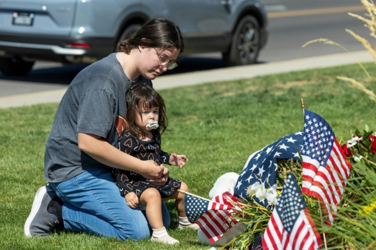 A woman pays tribute to Charlie Kirk at a memorial set up outside of Timpanogos Regional Hospital in Orem, Utah, on September 11, 2025