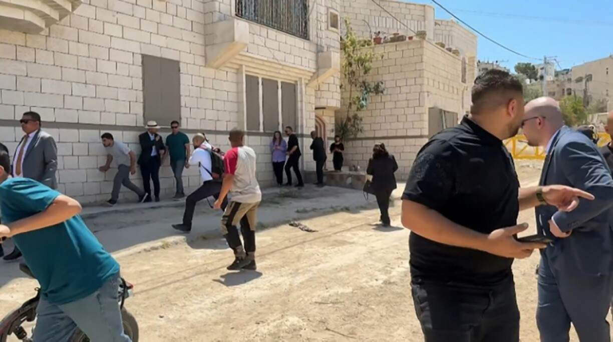 This frame grab from AFPTV footage shows members of a diplomatic delegation from the European Union reacting after shots were fired as they gathered in the eastern entrance of Jenin