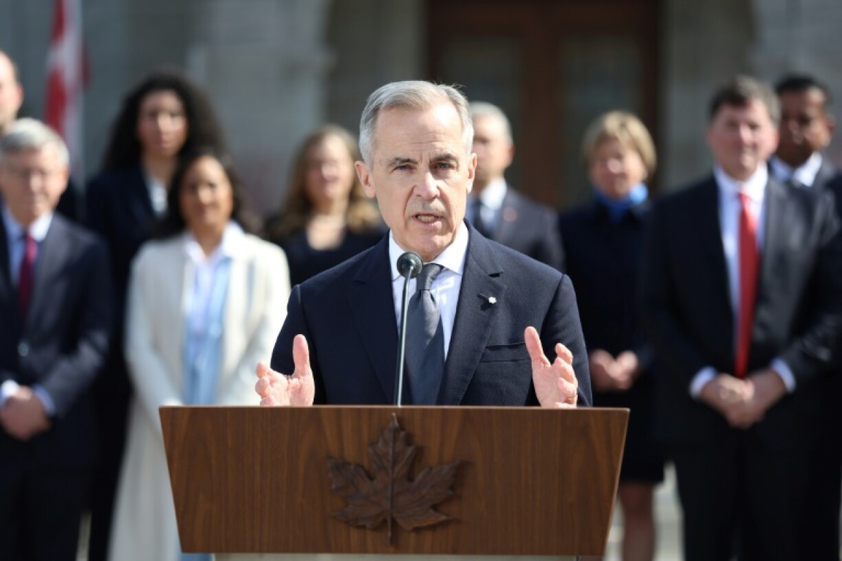 Canada's new Prime Minister Mark Carney speaks during a news conference at Rideau Hall after being sworn in, his cabinet behind him