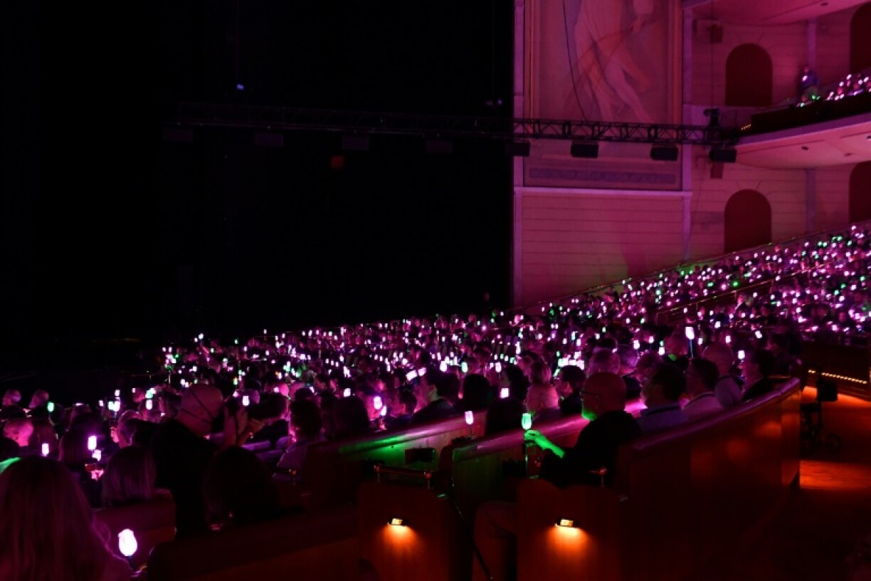 The finale of Universal's presentation featured thousands of plastic flowers held aloft by audience members to create a giant green-and-pink 'Wicked' themed electronic lightshow