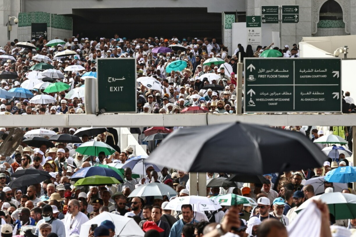 Des fidèles musulmans déambulent dans le complexe de la Grande Mosquée sous les brumisateurs installés dans la ville sainte de La Mecque, le 24 mai 2026 en Arabie saoudite, à la veille du pèlerinage annuel du Hajj