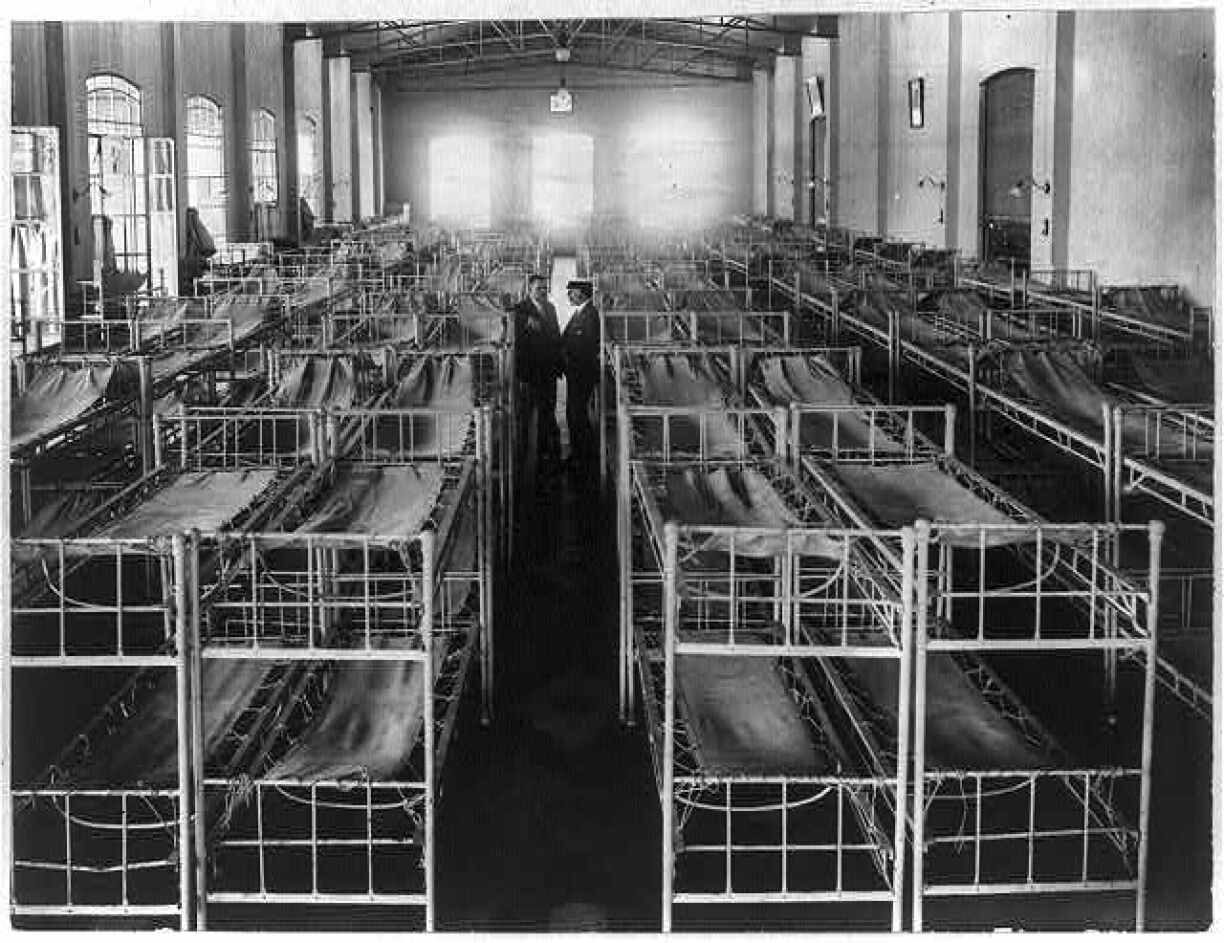 Double decker cots lined up in Immigrant Hotel, Buenos Aires, Argentina. Taken between 1890 and 1923.