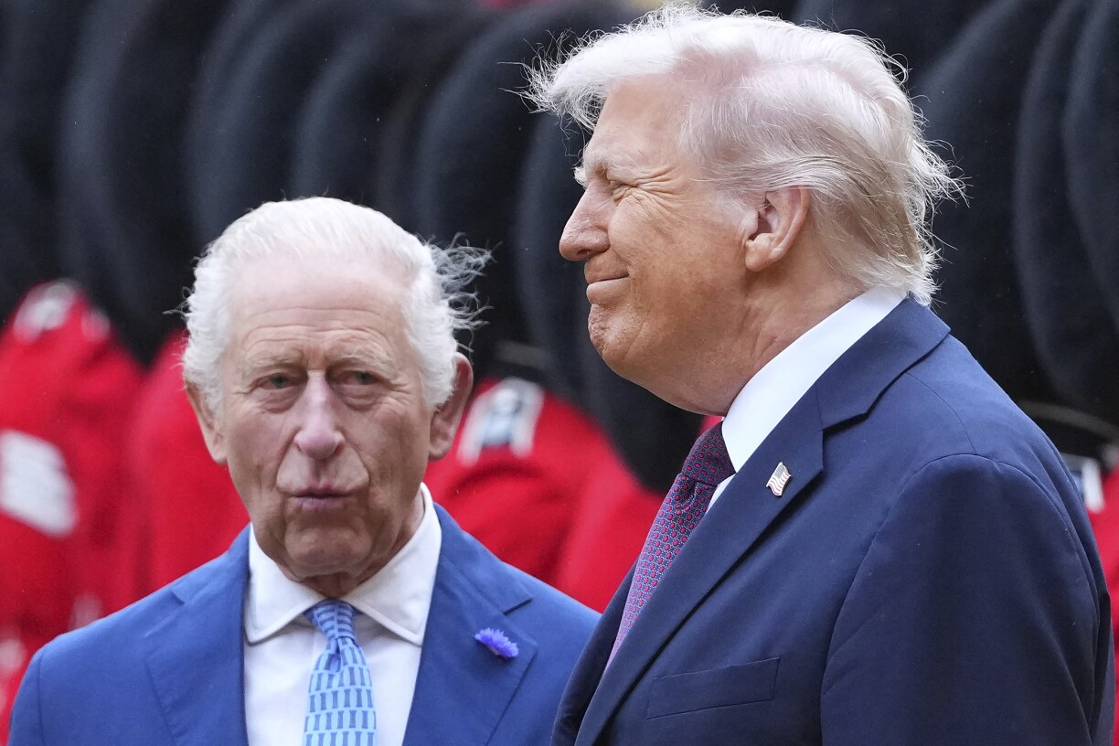 US President Donald Trump (R) and Britain's King Charles III inspect a guard of honour during a ceremonial welcome in the Quadrangle at Windsor Castle in Windsor on September 17, 2025, during the US president's second state visit.