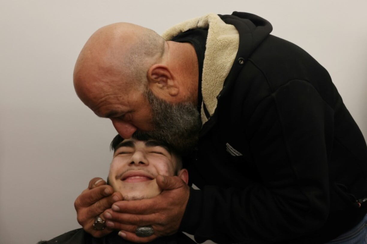 The uncle of 17-year-old Palestinian prisoner Qassem Jaafra kisses his forehead upon his arrival home in east Jerusalem