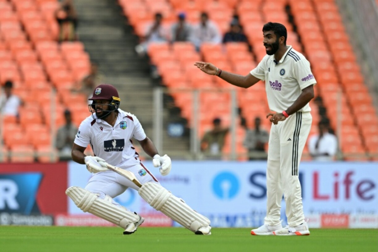 West Indies' John Campbell (L) runs as India's Jasprit Bumrah reacts during the first day of the first Test cricket between India and West Indies