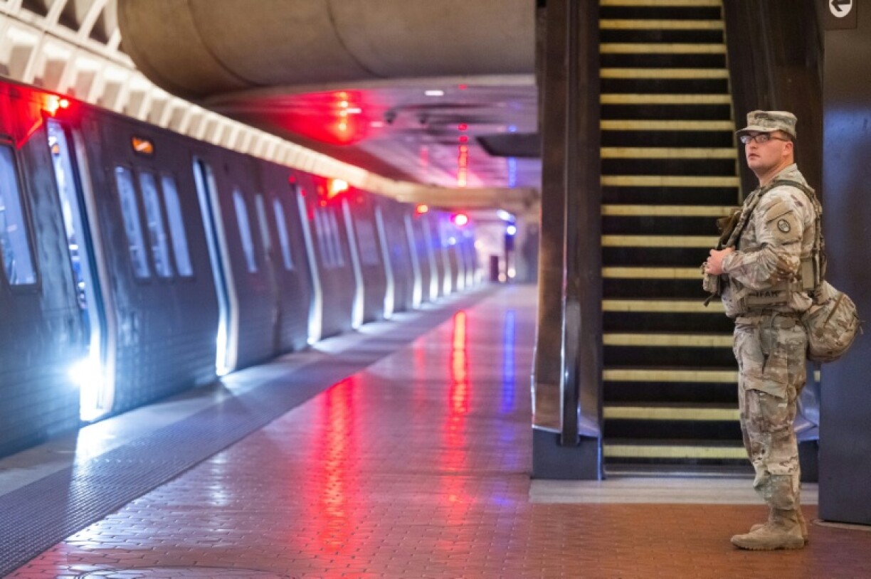A member of the National Guard patrols inside the Foggy Bottom Metrorail Station in Washington as part of President Donald Trump's effort to reduce crime in the US capital