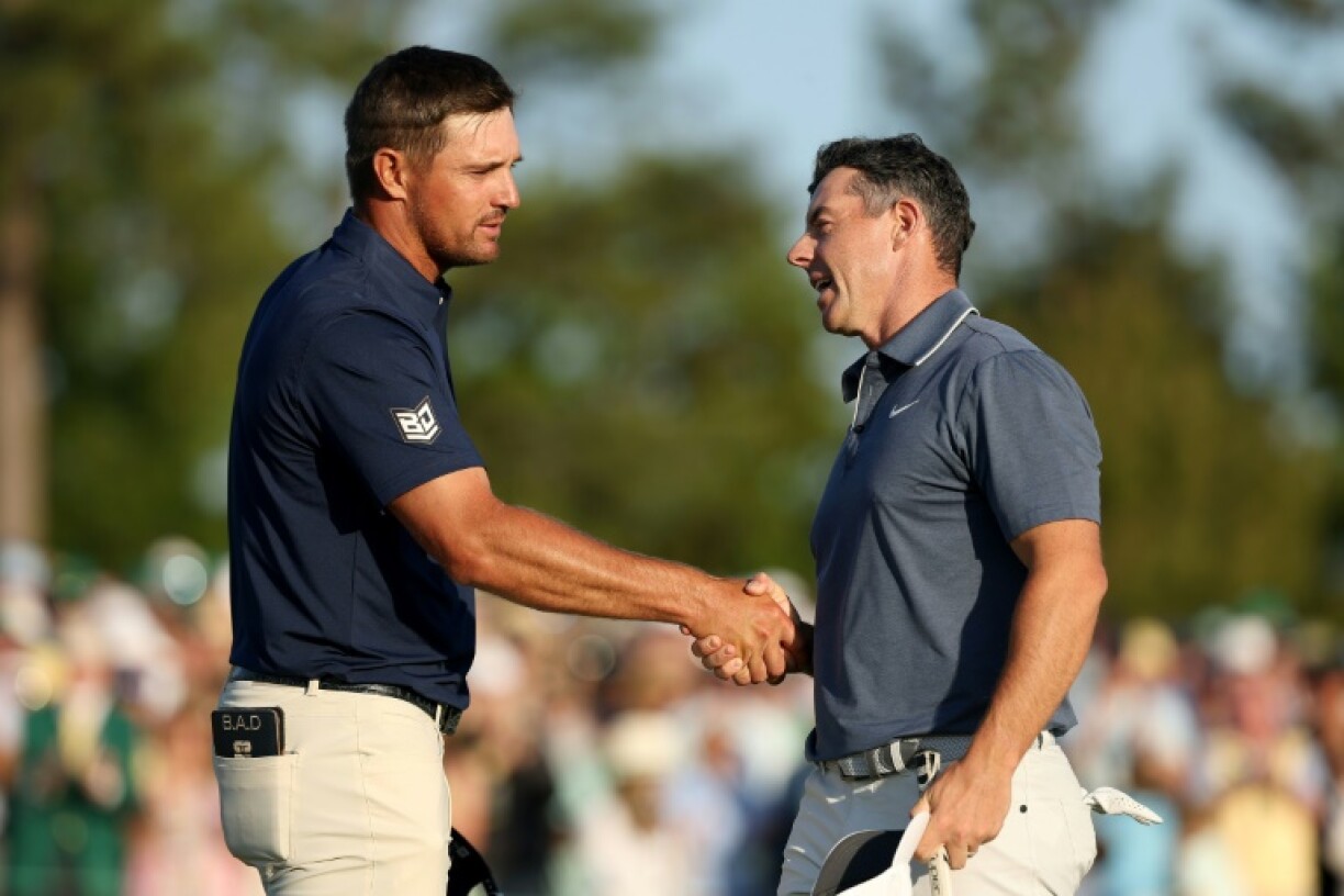 Rory McIlroy shakes hands with playing partner Bryson DeChambeau at the final hole of regulation at the Masters, where he triumphed in a playoff over Justin Rose