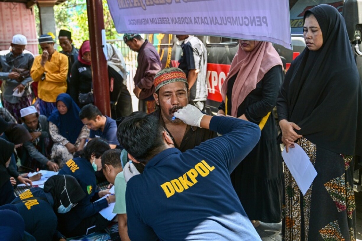 Authorities have taken DNA samples from family members waiting to find loved ones missing after the collapse of an Indonesian school