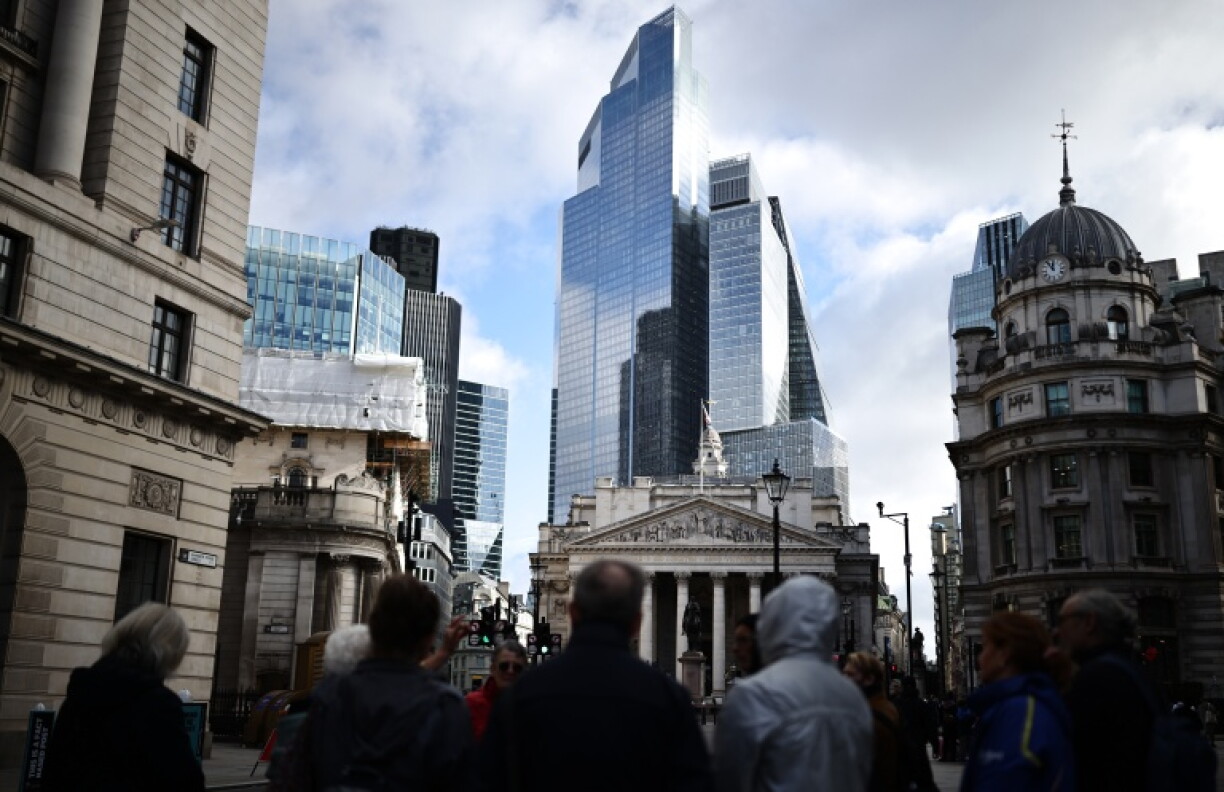 People walk bear the Bank of England and the Royal Exchange in the City of London