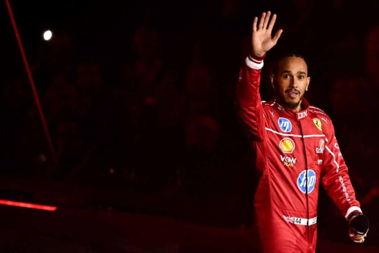 'Full of life': Seven-times world champion Lewis Hamilton, now with Ferrari, arrives on stage for the presentation of his new car during the 2025 Formula One season launch at London's O2 Arena