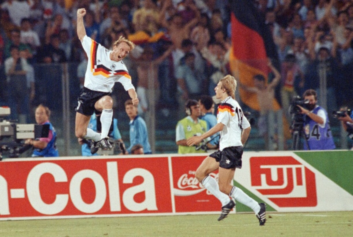 Andreas Brehme (L) celebrates his most famous moment scoring the penalty that secured West Germany the 1990 World Cup trophy