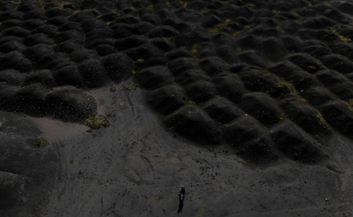 Lunar landscape: a man walks by the huge waste dump around Elbasan's steelworks complex
