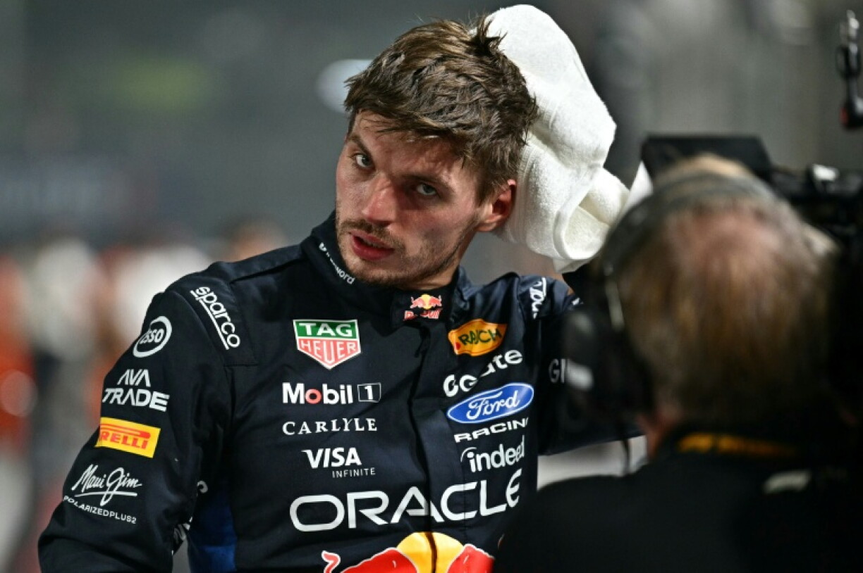 Red Bull's Max Verstappen wipes off his sweat after taking pole position during the qualifying session for the Formula One Singapore Grand Prix