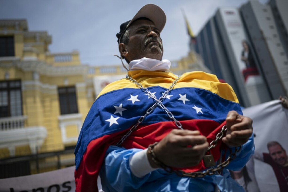 Venezuelan citizens gather at the country's embassy in Lima, Peru to hold a protest against President Nicolas Maduro's inauguration for a third term in Caracas