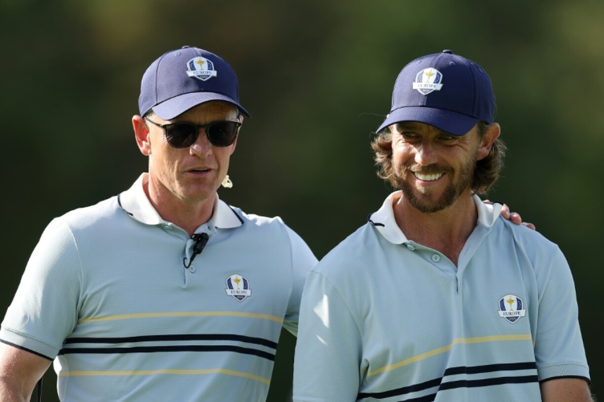 Europe captain Luke Donald, left, talks with England's Tommy Fleetwood, who went unbeaten as Europe seized a 5.5-2.5 lead after day one of the Ryder Cup