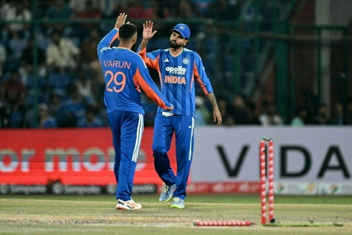 India's Varun Chakravarthy (L) and captain Shreyas Iyer during the T20 international against Afghanistan in New Delhi on September 13, 2026