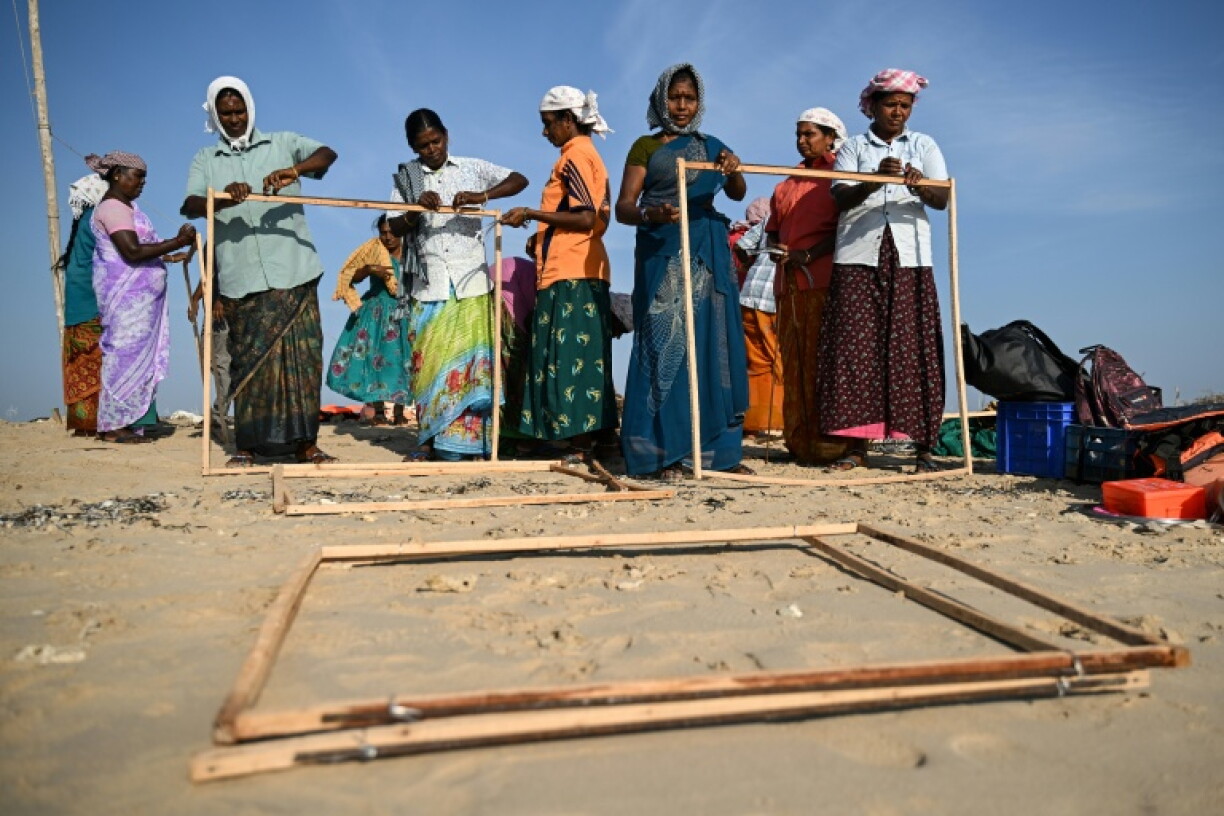 Members of a fishing community prepare frames for restoration work protecting Kariyachalli Island, off the coast of Thoothukudi in India's Tamil Nadu state