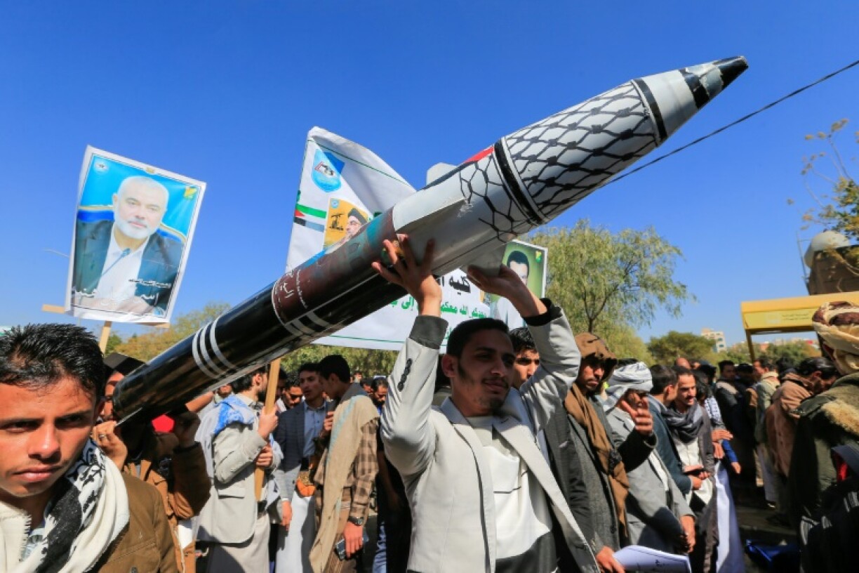 Yemenis carry a mock missile during a rally in solidarity with Palestinians, in the Huthi-controlled capital Sanaa