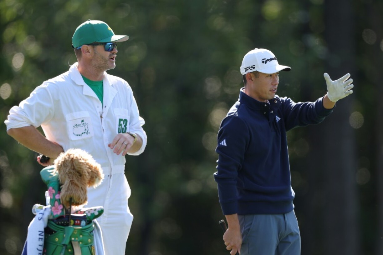 Fourth-ranked Collin Morikawa, right, speaks with his caddie Jonathan Jakovac during a practice round for the 89th Masters