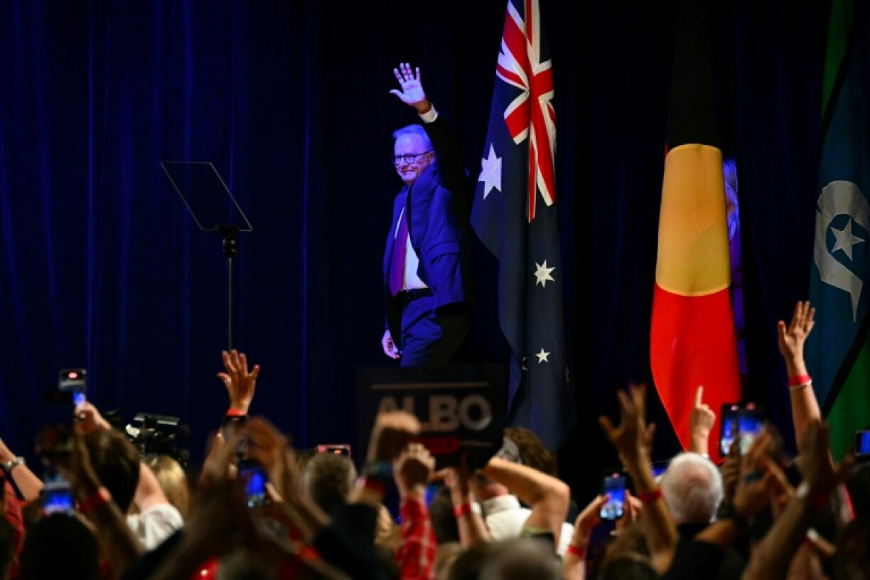 Australia's Prime Minister Anthony Albanese waves as he arrives onstage in Sydney after winning a general election