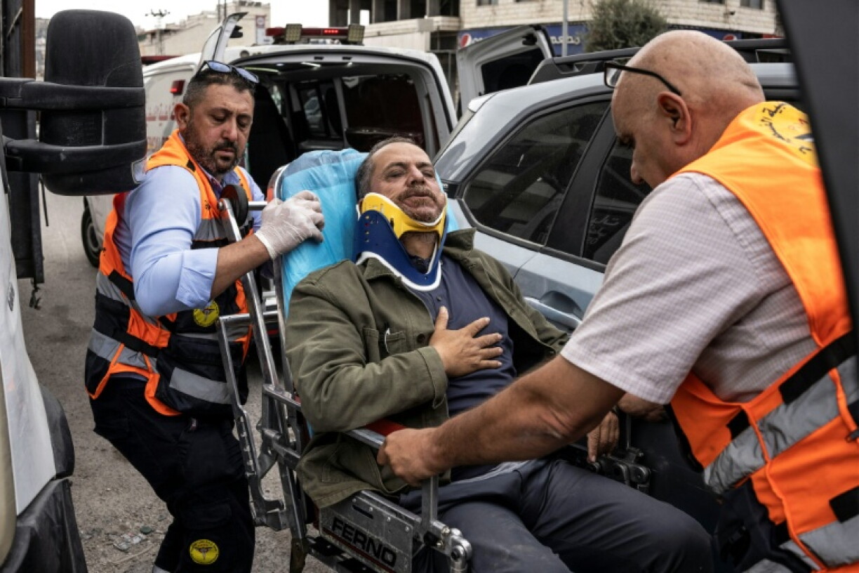 Palesitnian first responders carry into an ambulance AFP photographer Jaafar Ashtiyeh after he was beaten by Israelis in Aqraba in the Israeli-occupied West Bank