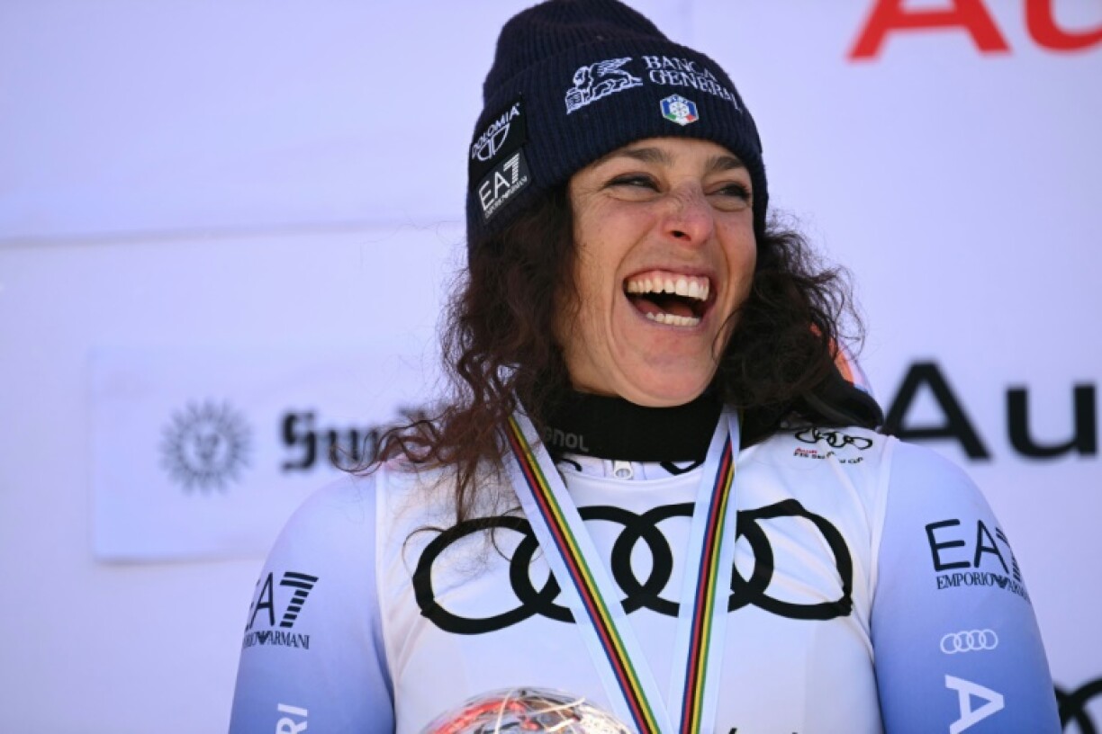 Federica Brignone celebrates on the podium after women's downhill in Sun Valley was cancelled, handing her the overall title