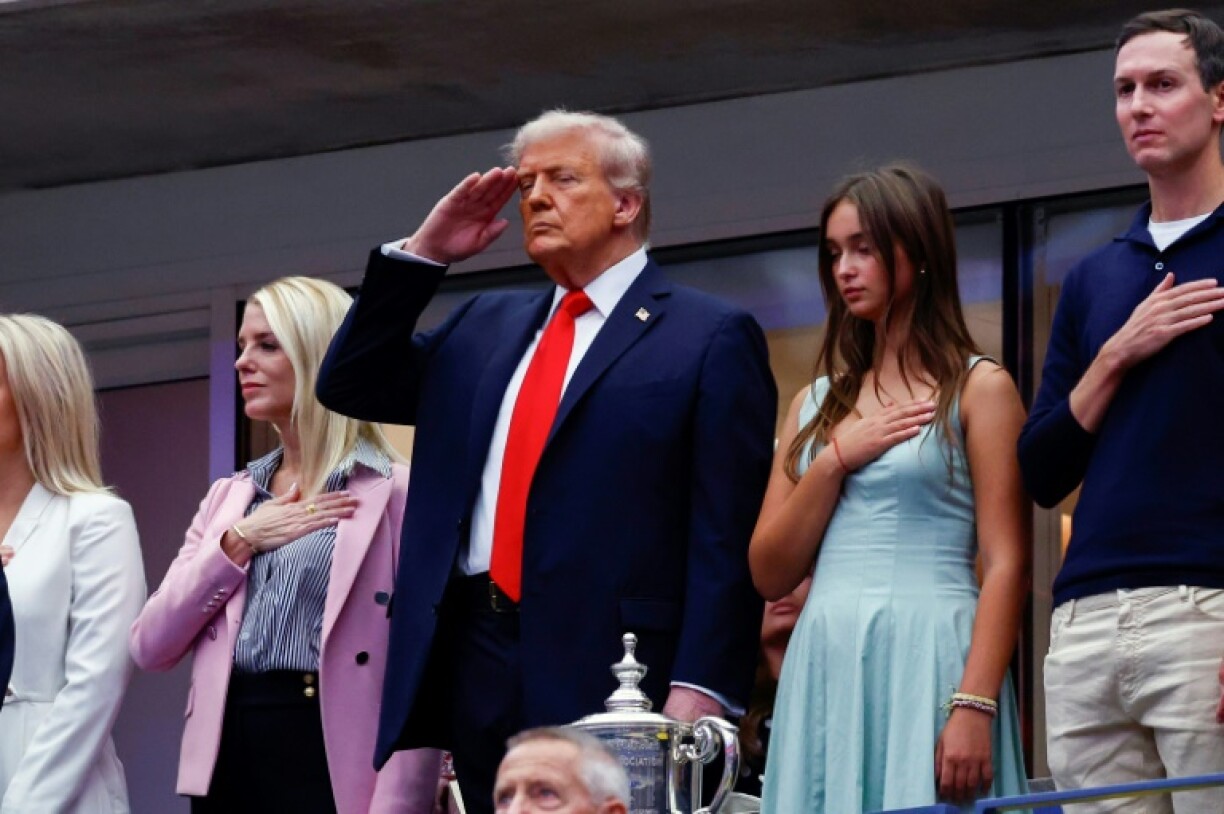 President Donald Trump salutes during the national anthem ahead of the US Open final