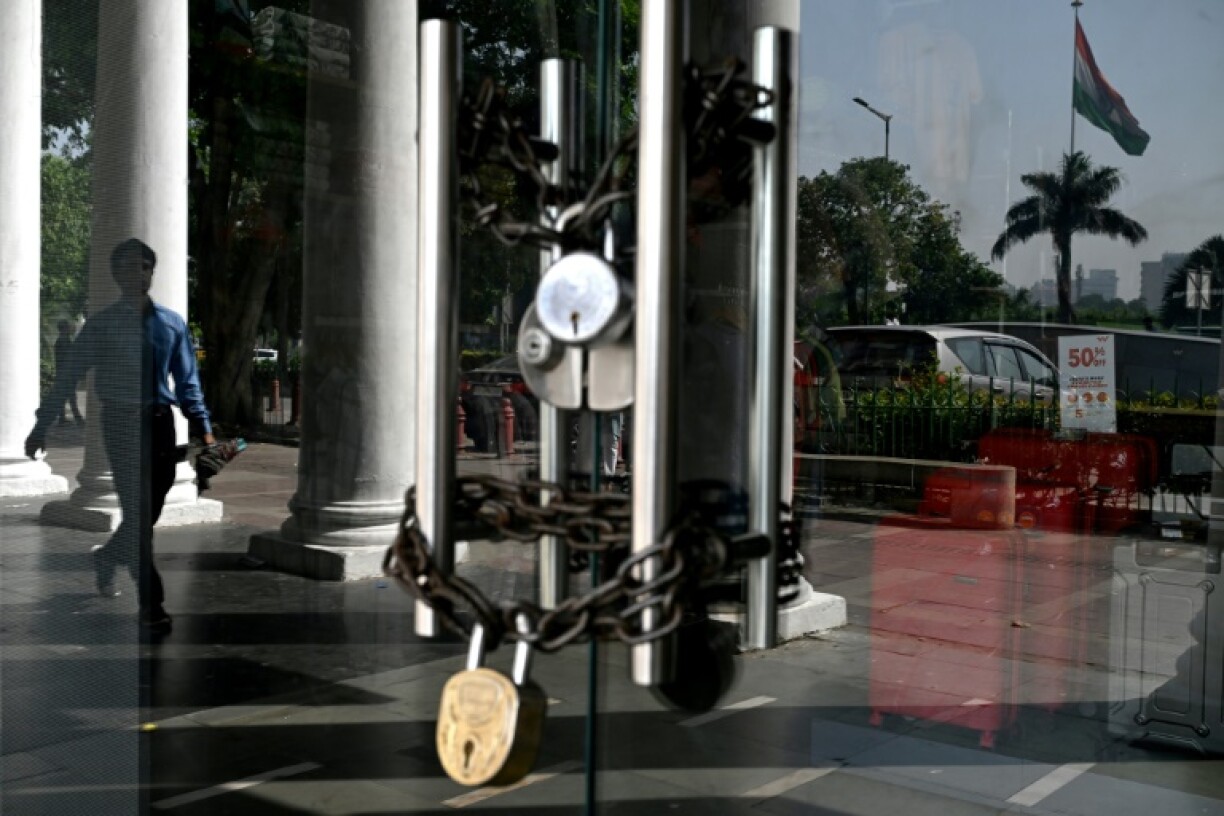 A man walks past a closed shop during a shutdown called by different trade unions to show solidarity with victims of the Pahalgam tourist attack, in New Delhi on April 25
