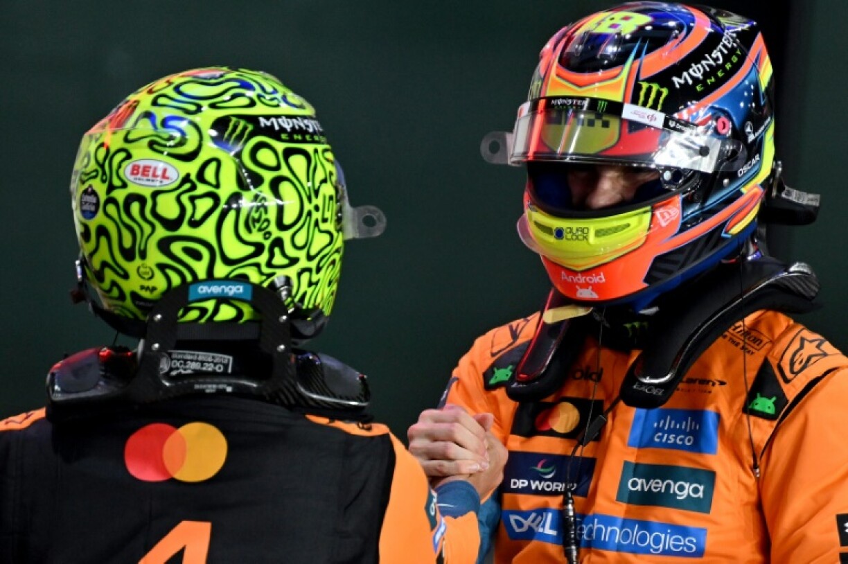McLaren's Oscar Piastri (R) shakes hands with Lando Norris after taking pole position during sprint qualifying session ahead of the Formula One Qatar Grand Prix
