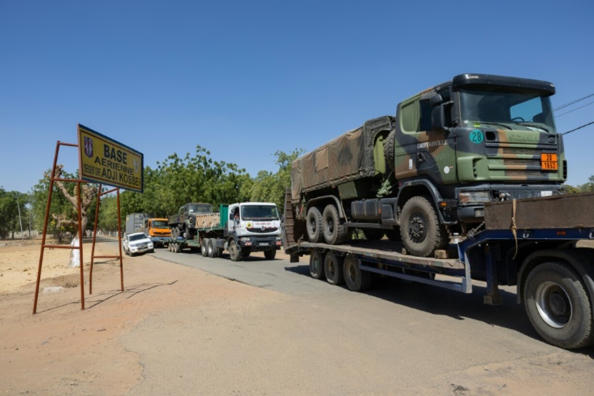 Trucks carrying French army vehicles and equipment leaving the Kossei base