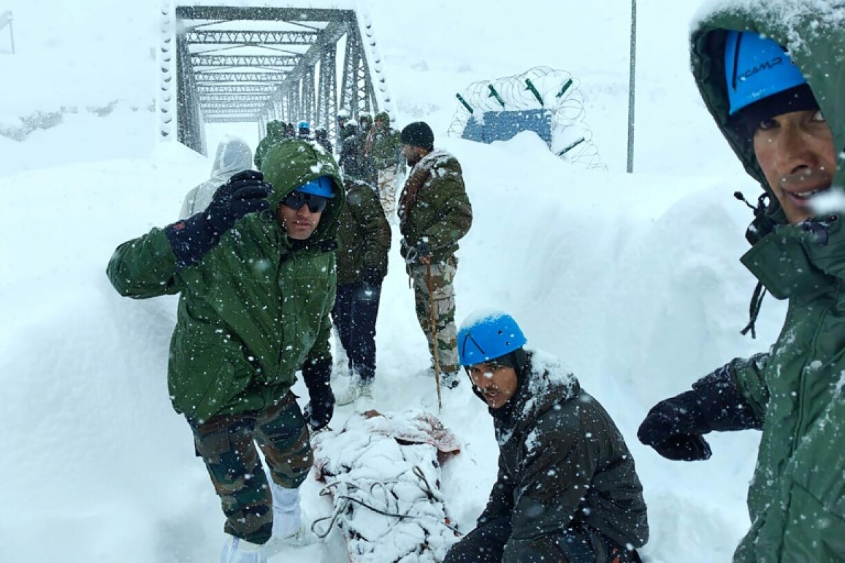 Indian rescuers hurried in sub-zero temperatures to dig out workers buried by an avalanche in a remote border area