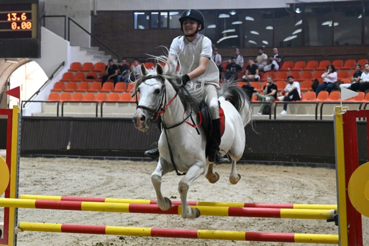 A rider competes at the Al-Nasr Equestrian Show Jumping Championship in Dimas, northwest of Damascus