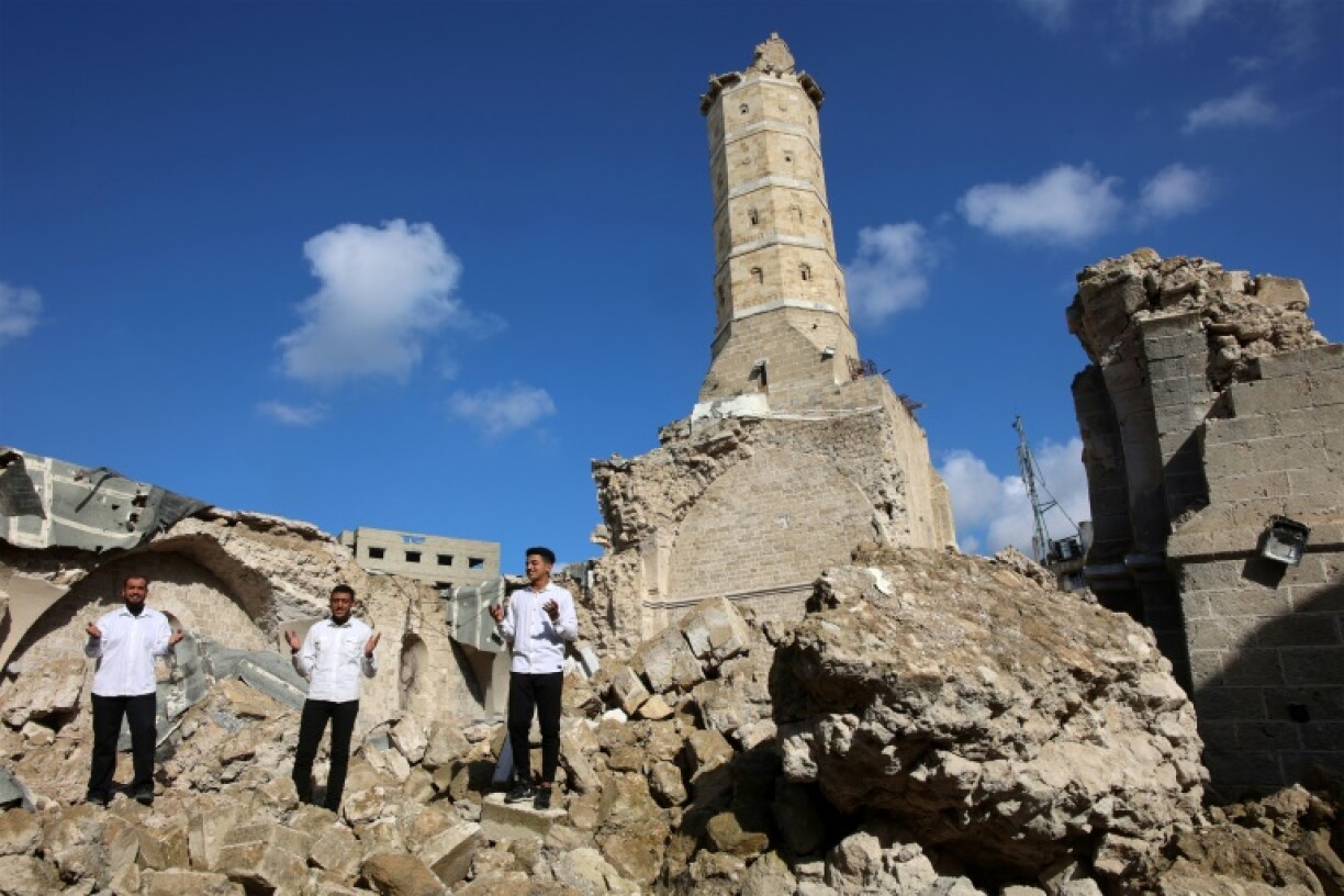 Palestinians pray amid the rubble of Gaza City's historic Omari Mosque.