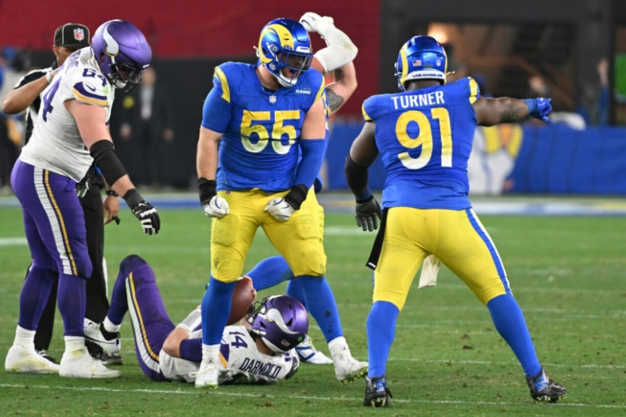 Braden Fiske of the Los Angeles Rams celebrates with teammate Kobie Turner after a sack of Minnesota Vikings quarterback sam Darnold