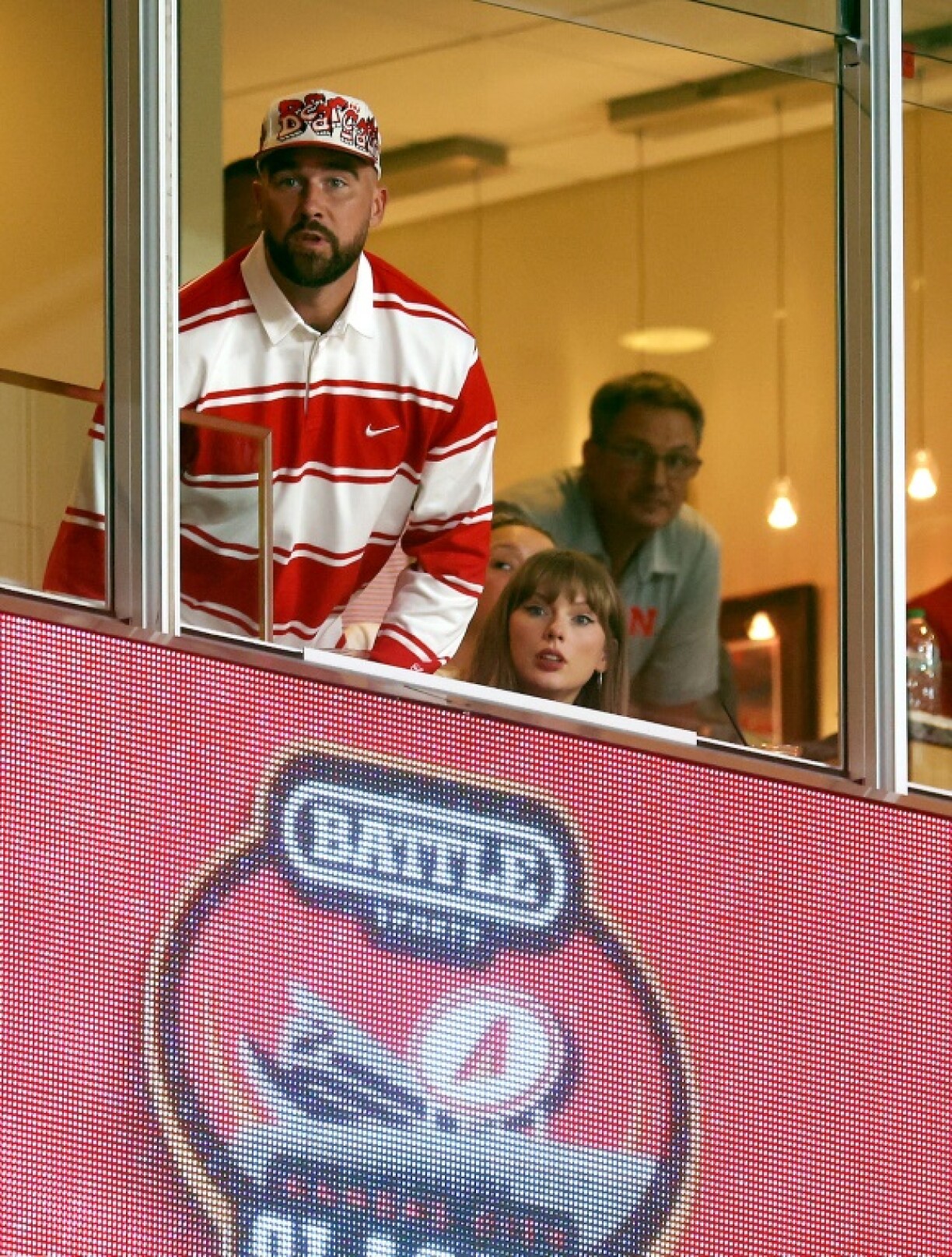 Tight end Travis Kelce, left, of the Kansas City Chiefs and fiance Taylor Swift watch a college game in Kansas City