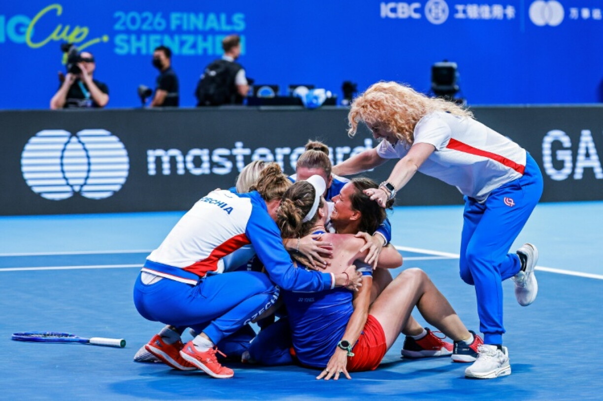 Linda Noskova (front 2L) is mobbed by her team-mates after clinching the winning point for the Czechs