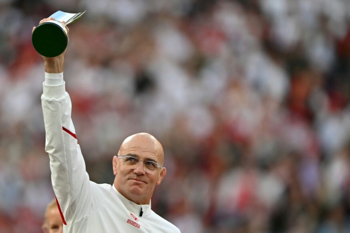 England's coach John Mitchell holds the coach of the year award following his side's 33-13 win over Canada in the Women's Rugby World Cup final at Twickenham