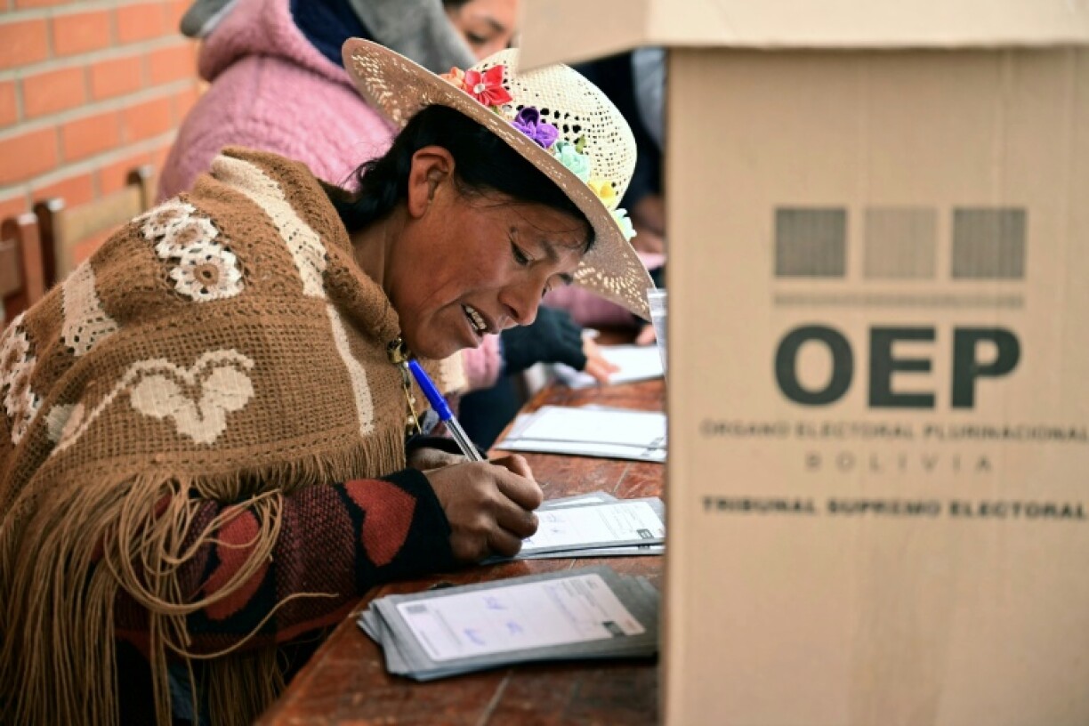 An Aymara woman prepares to cast her vote during the presidential runoff election, in Laja, some 30 km west of La Paz, on October 19, 2025