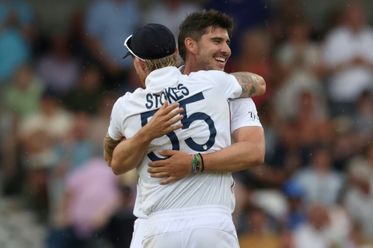 England fast bowler Josh Tongue (R) celebrates with skipper Ben Stokes after dismissing India's Prasidh Krishna