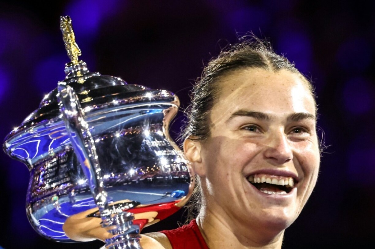 Aryna Sabalenka celebrates with the Daphne Akhurst Memorial Cup after her Australian Open victory against Zheng Qinwen in 2024