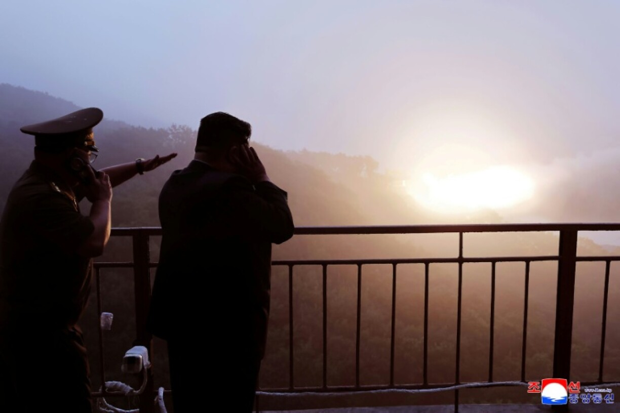 This picture taken on September 8, 2025 and released from North Korea's official Korean Central News Agency (KCNA) via KNS on September 9, 2023 shows North Korea's leader Kim Jong Un (2nd L) inspecting the ground combustion of a high-output solid fuel engine using carbon fiber composites, at an undisclosed location in North Korea.