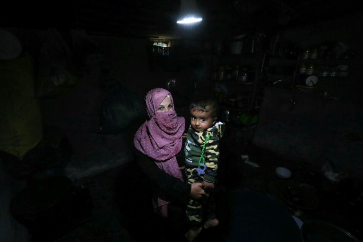 A woman and her baby in a tent at the Atme camp for displaced people in northwest Syria
