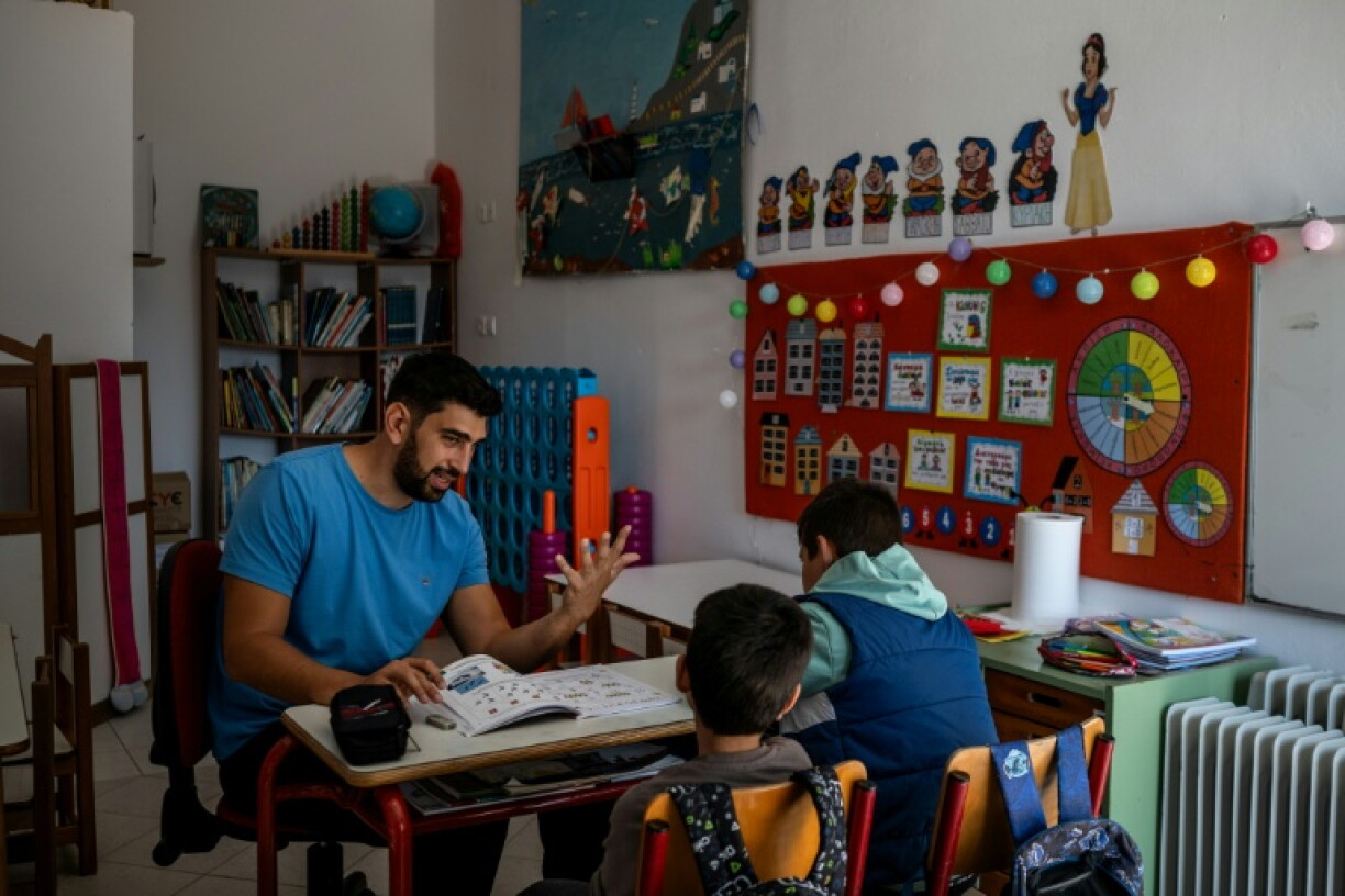 Teacher Konstantinos Fantelas with his last two pupils in Thymaina's school