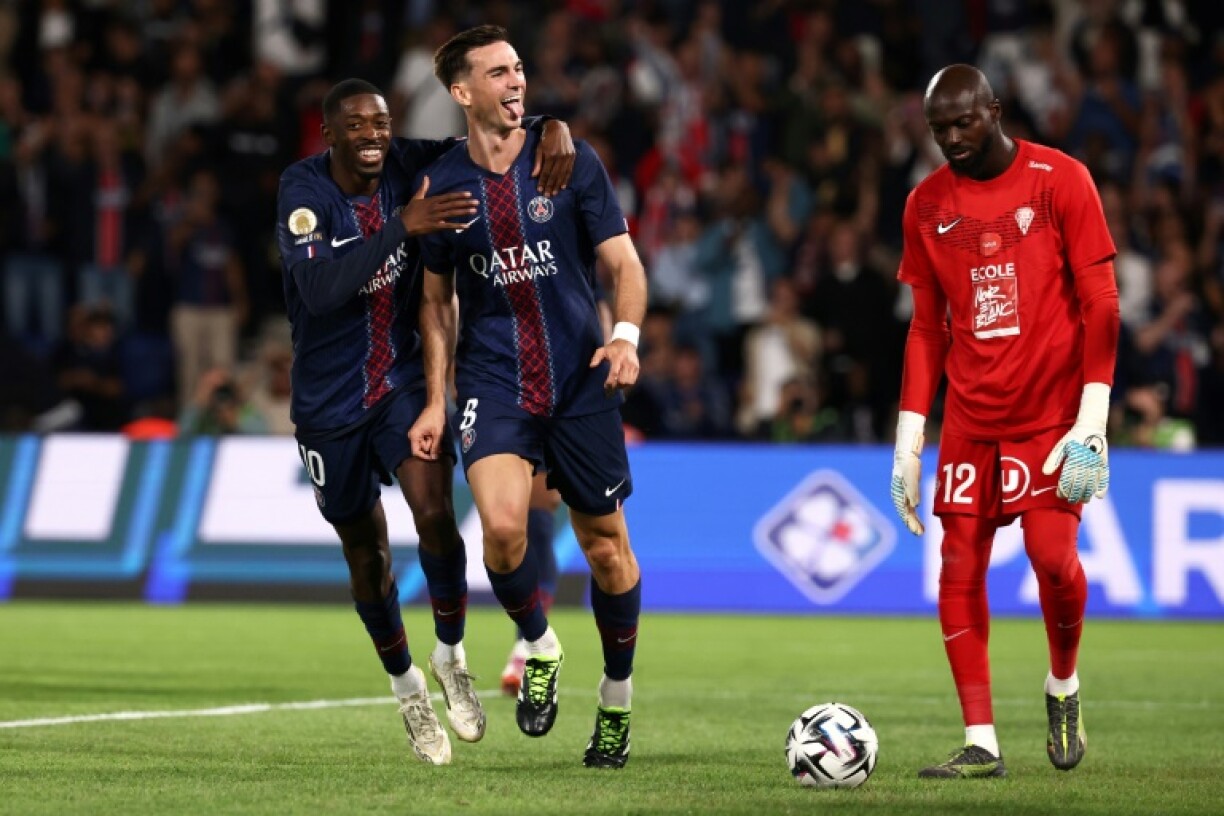 Fabian Ruiz celebrates with Ousmane Dembele (L) after scoring for Paris Saint-Germain against Angers on Friday